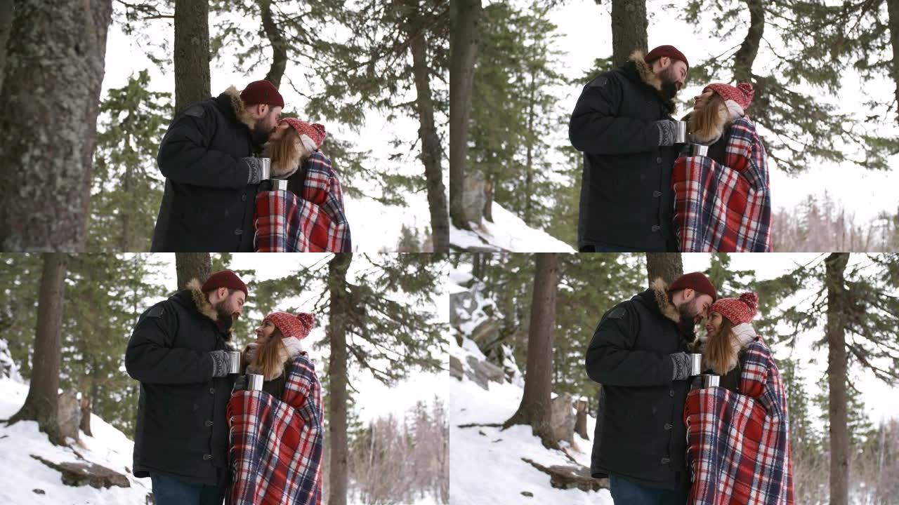 情侣在山区冬季徒步旅行时接吻