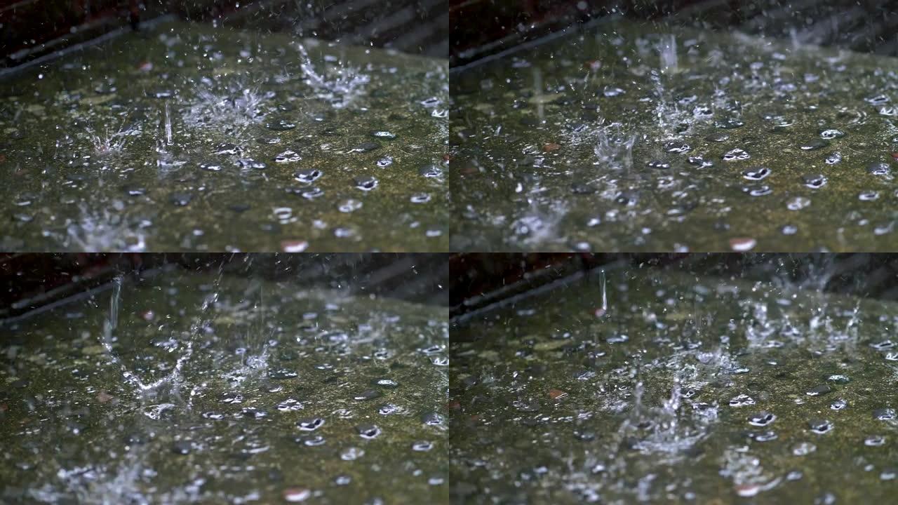 雨滴落在地面上的慢动作镜头，导致水花飞溅。4K, UHD