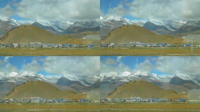 西藏平原村庄后面白雪皑皑的喜马拉雅山风景如画