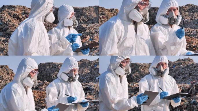 两名亚洲科学家穿着化学防护服病毒COVID-19.Biologists在废物中进行研究在电晕病毒调查