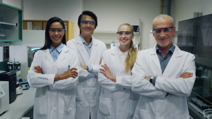 戴着防护眼镜的科学家的肖像对实验室相机研究的巨大成果感到满意