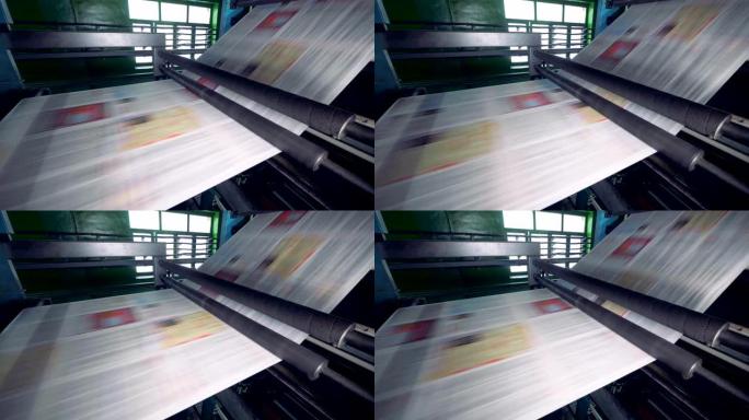 印刷设备在工厂的生产线上移动纸张。4K。