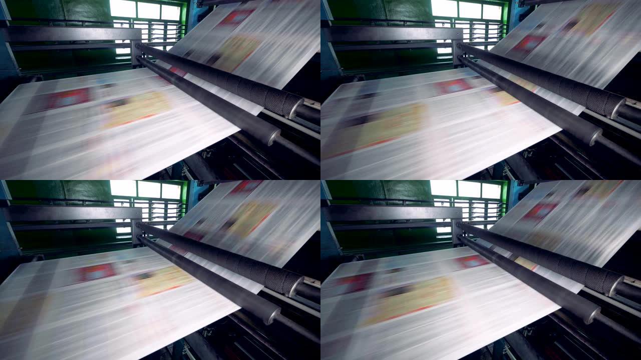 印刷设备在工厂的生产线上移动纸张。4K。