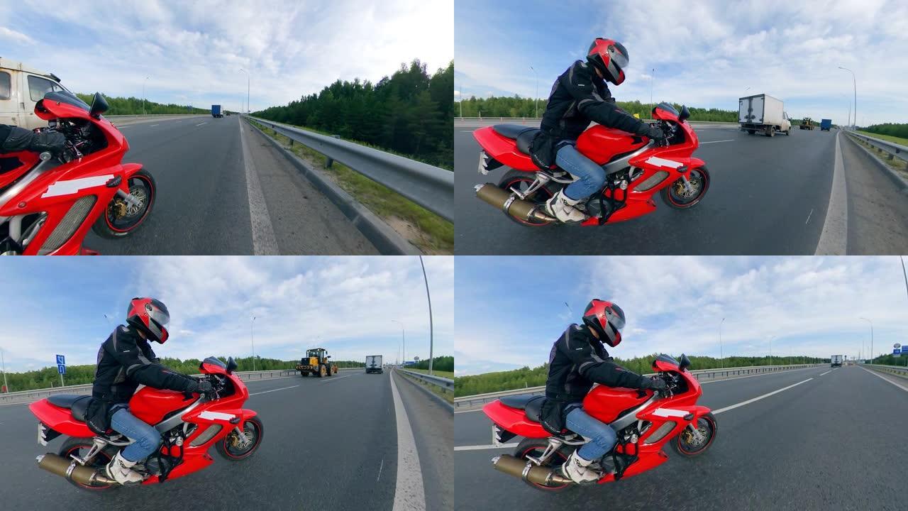 驾驶员沿着高速公路骑摩托车的侧视图。路上的摩托车。
