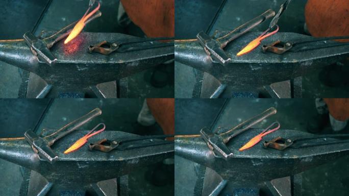 加热的金属仪器在砧上留下锤子