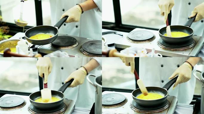 厨师烹饪煎蛋卷作为自助早餐。