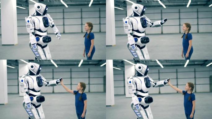 机器人和女孩触摸手。未来主义人形机器人
