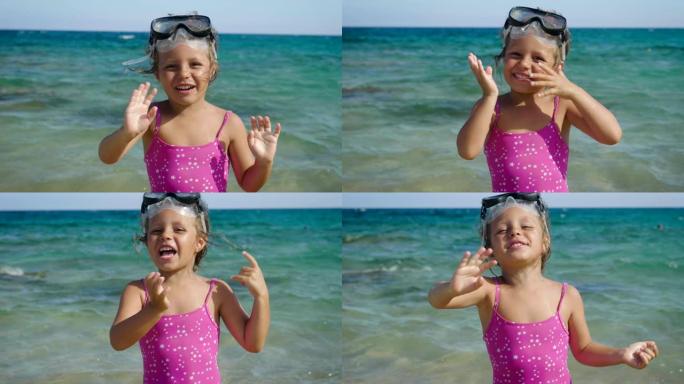 美丽的小女孩在海上玩耍，可爱的面具微笑游泳