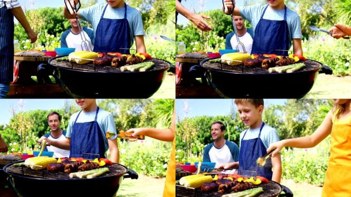 孩子们在烧烤时烤肉和蔬菜