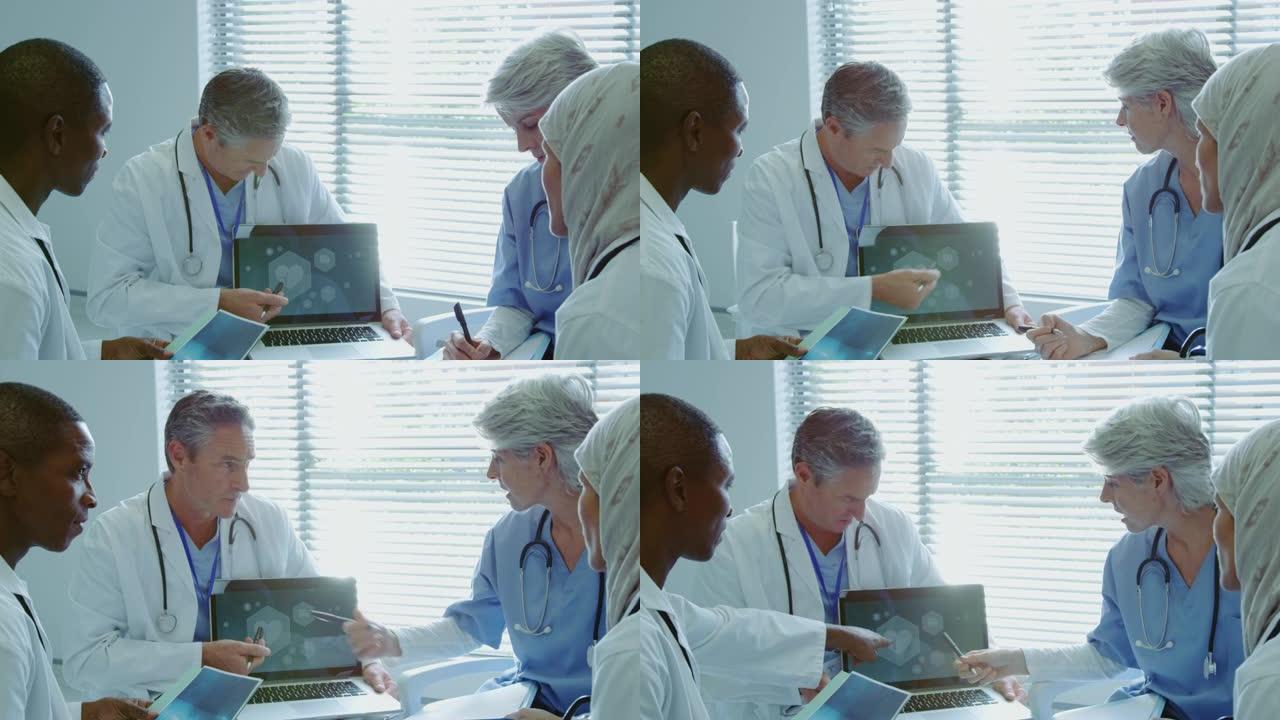 多种族医生在医院笔记本电脑上讨论的前视图