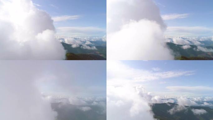 风景如画的群山上空的云层飞行。过度下垂