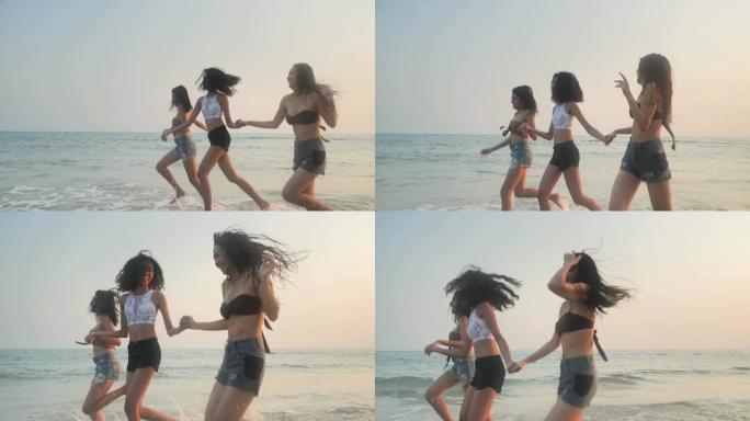 亚洲三个年轻的女性朋友在日落海滩玩得开心。海滩假期旅游概念。旅游电影
