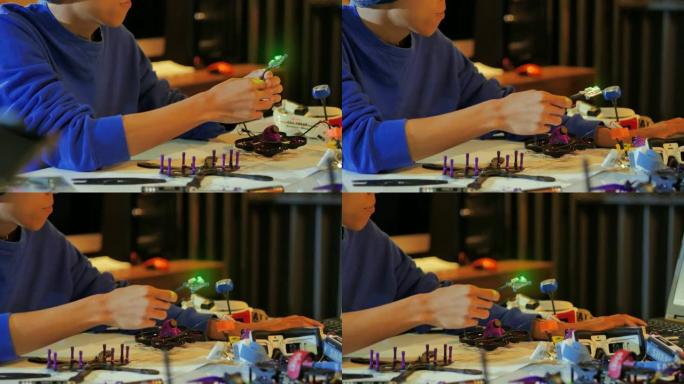 一个人在机器人俱乐部项目的全功能可编程机器人上工作。创意设计师在车间测试机器人原型。创新，科学概念