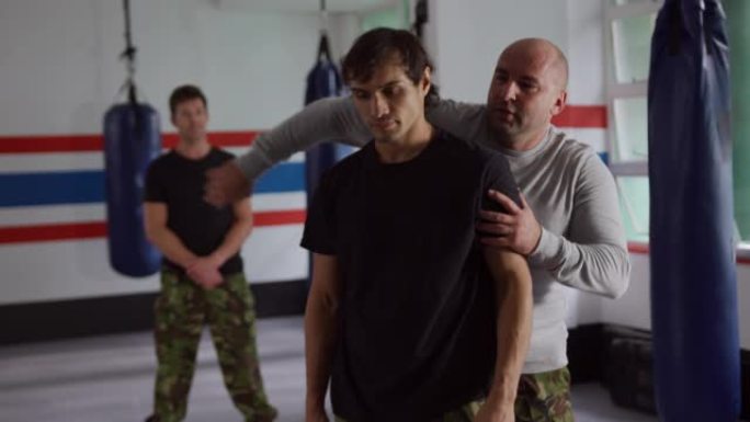 高加索人从健身房的教练那里学习自我防御