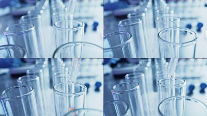 药剂学实验室: 移液器将液体滴入试管，医学研究和分析。科学实验室; 滴管用用于DNA研究的生化流体填