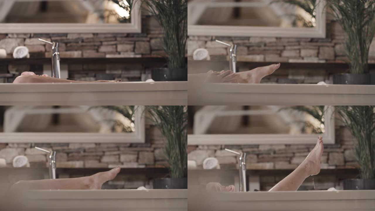 SLO MO女人在泡泡浴中洗腿