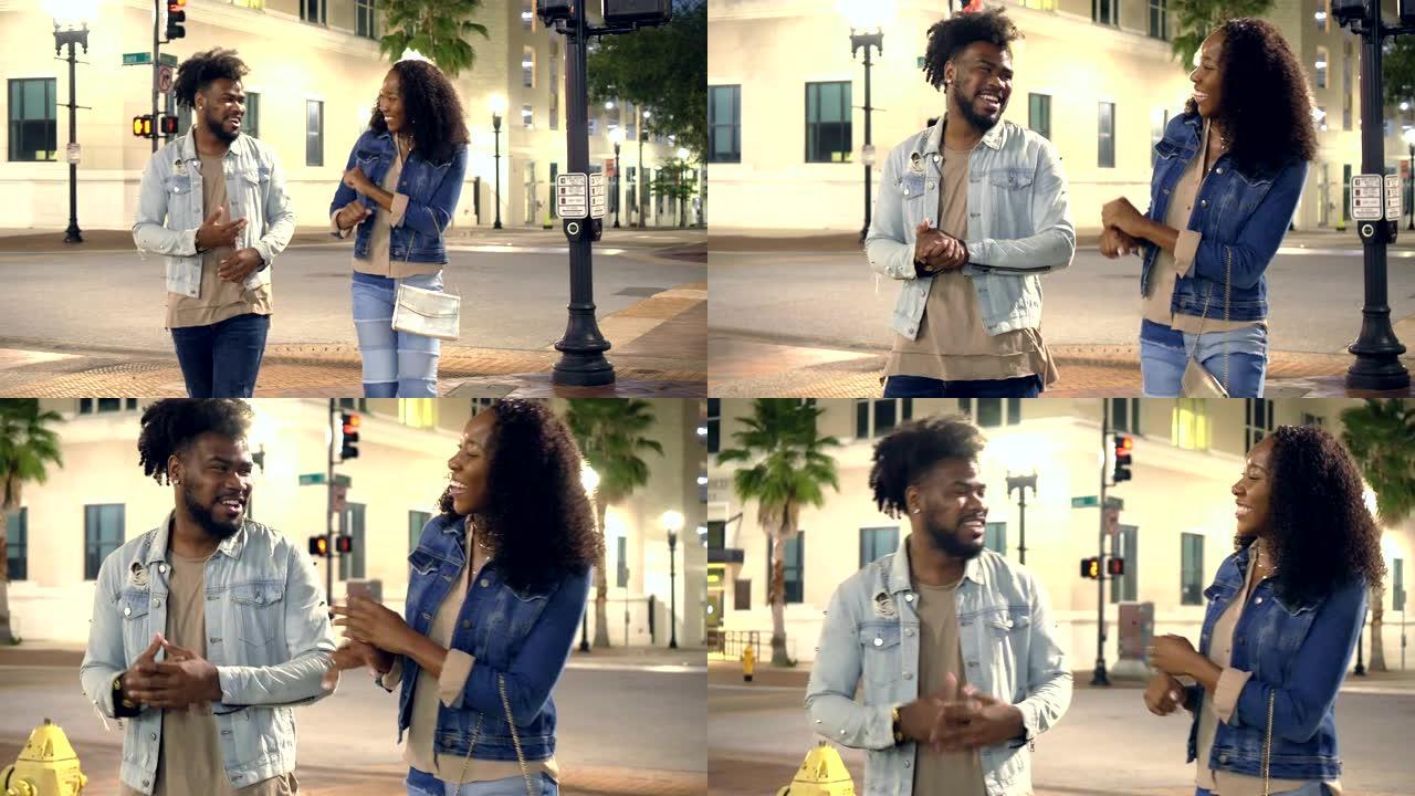 年轻的非洲裔美国夫妇在城市散步，聊天