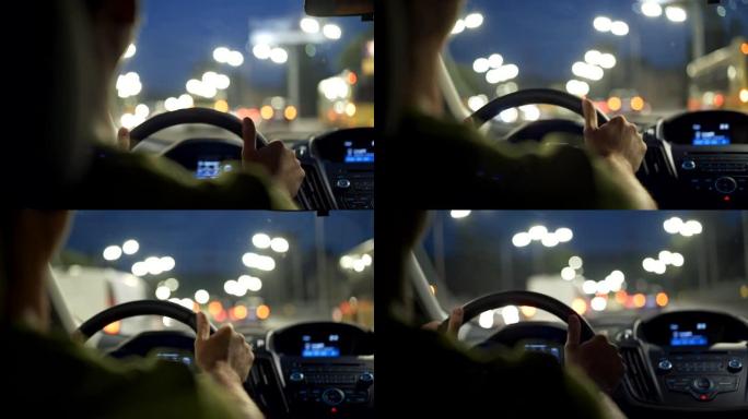 男人在夜城开车听音乐。黑色视图