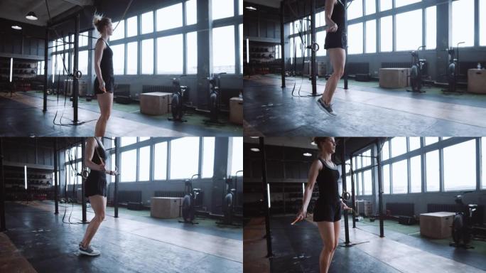 侧视图美丽的年轻白人妇女在健身房慢动作中跳绳锻炼。积极健康的生活方式。