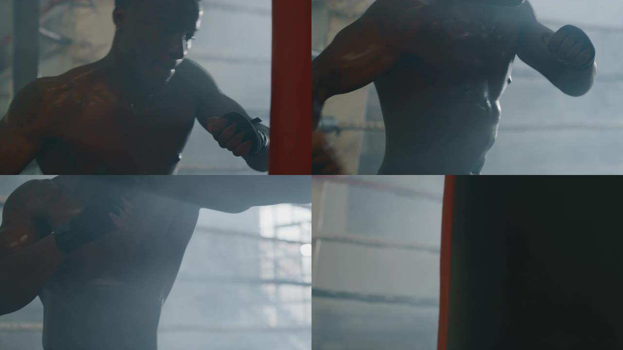 一个专业的年轻肌肉发达的非洲男子的电影镜头正在带戒指的健身房里用沙袋练习太极拳锻炼