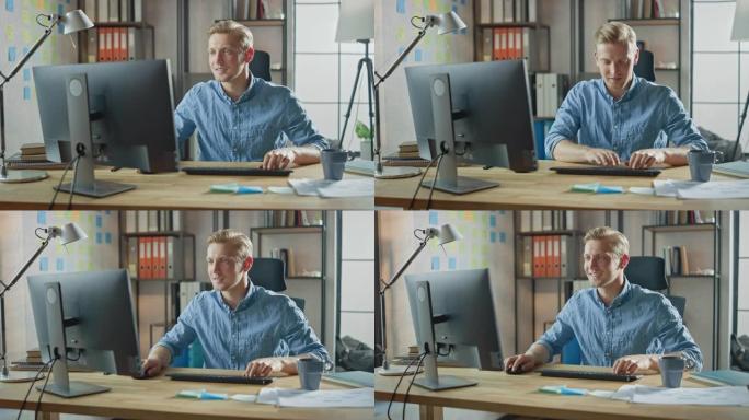 坐在办公桌前的创意企业家在时尚办公室的台式计算机上工作。英俊的白人男人使用电脑。背景时尚办公室工作室