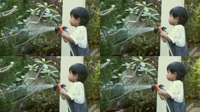 男孩浇水植物男孩浇水植物喷水