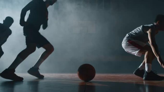 年轻职业男球员的电影慢动作镜头正在健身房练习艰苦的篮球锻炼