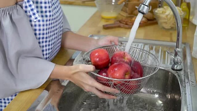 慢动作; 在厨房房间洗苹果。