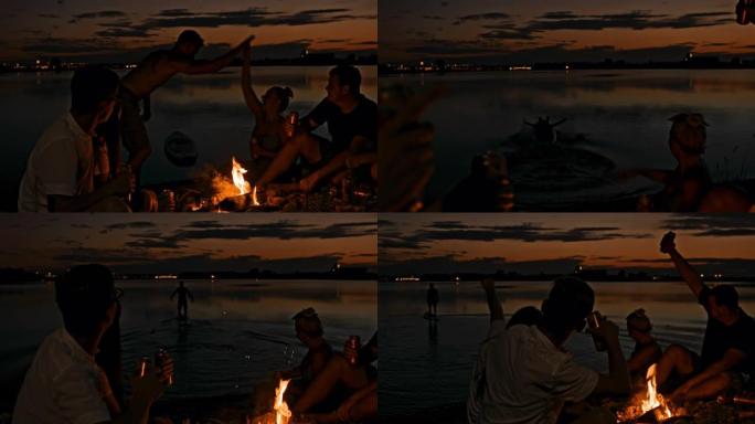 SLO MO年轻人在湖边的篝火旁玩耍