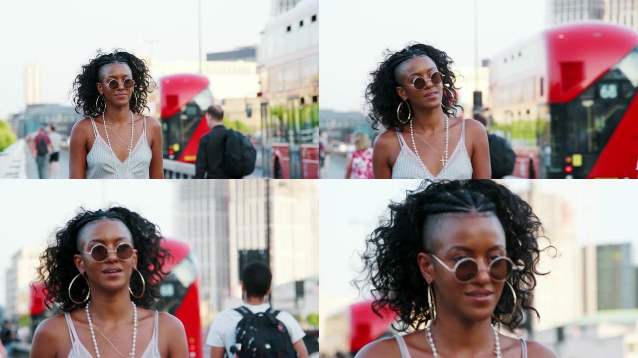 时髦的年轻黑人妇女在城市的一座桥上行走，特写