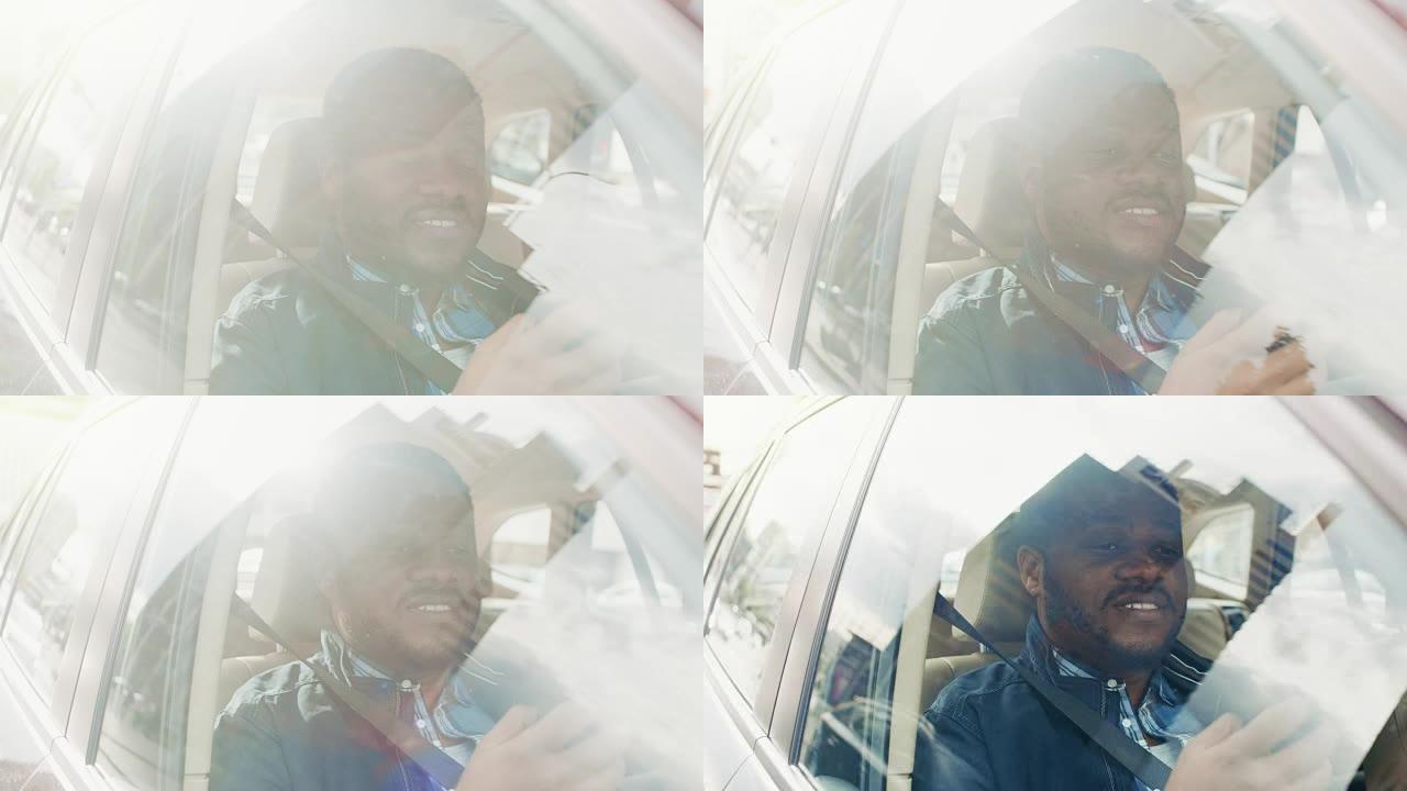 英俊的黑人坐在汽车上，坐在乘客座位上，用一只手使用智能手机，输入消息，通过互联网浏览。从车外拍摄的摄