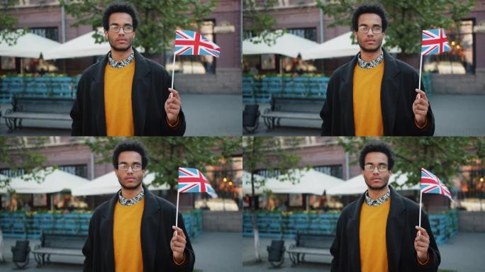 非裔美国游客举着英国国旗站在街上的肖像