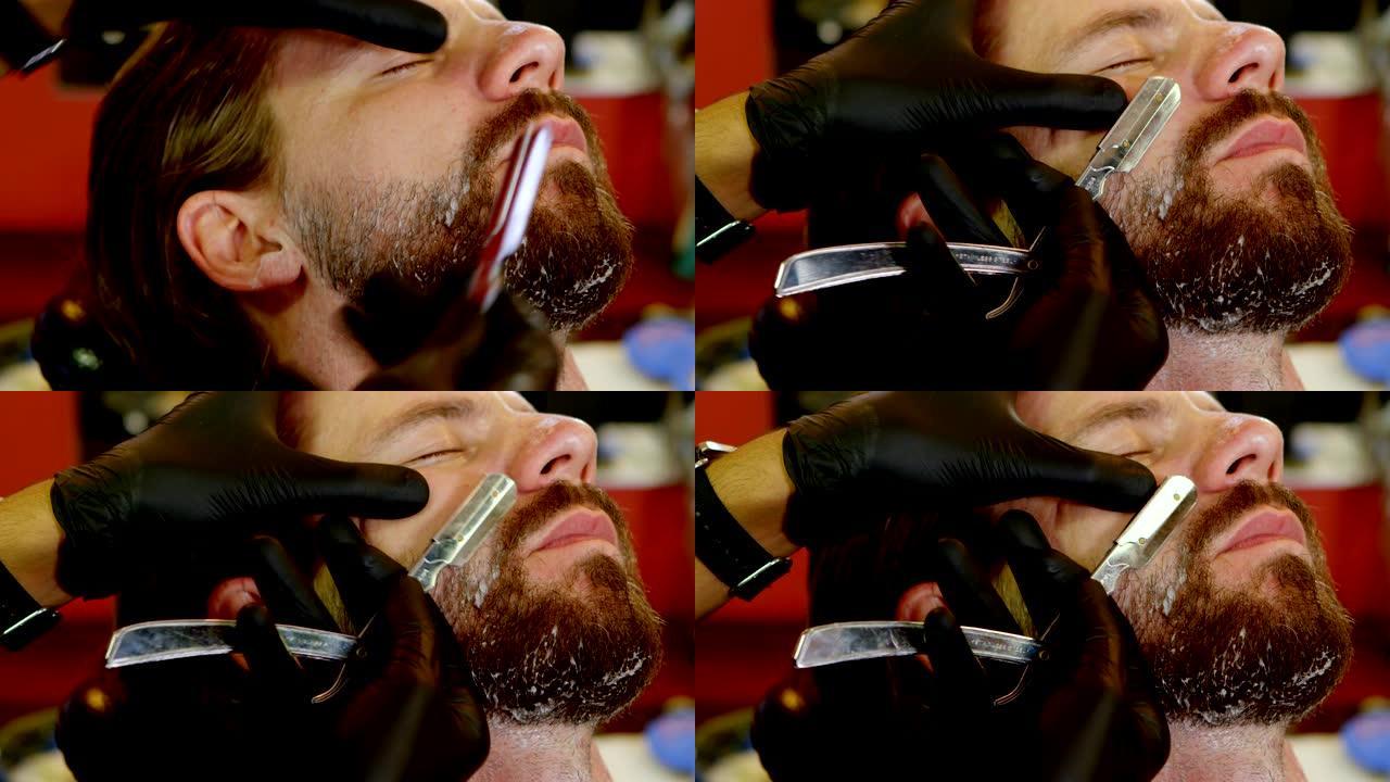 男人用剃刀刮胡子4k