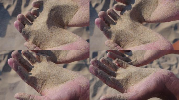 手里拿着沙子。慢动作。