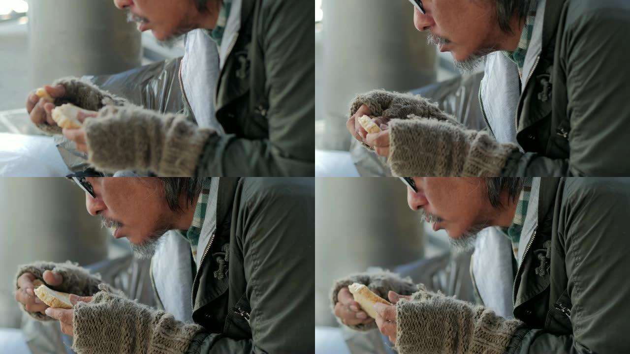 可怜的人坐在街上吃蜜饯。志愿服务，给予