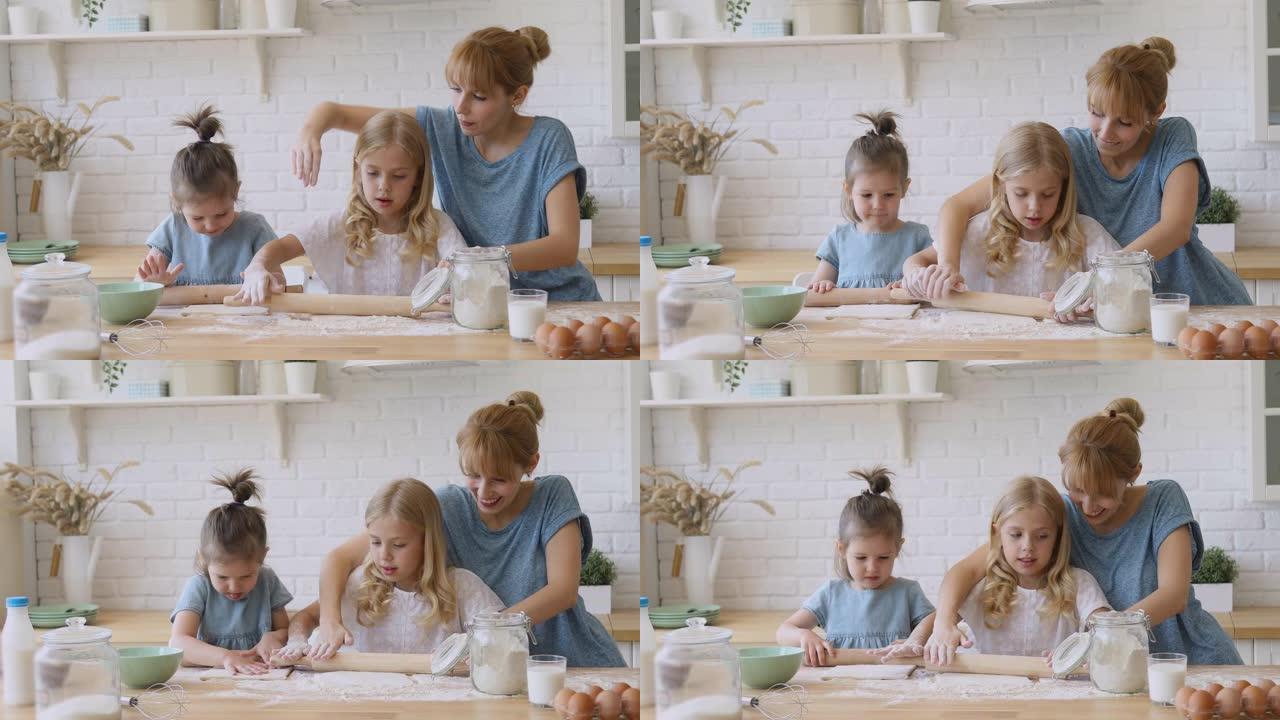 快乐的母亲教孩子们女儿在厨房里滚动面团