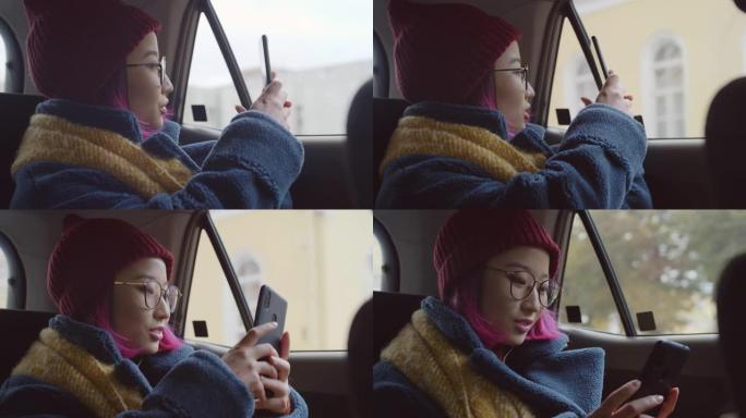开朗的亚洲女游客乘车并通过电话拍照
