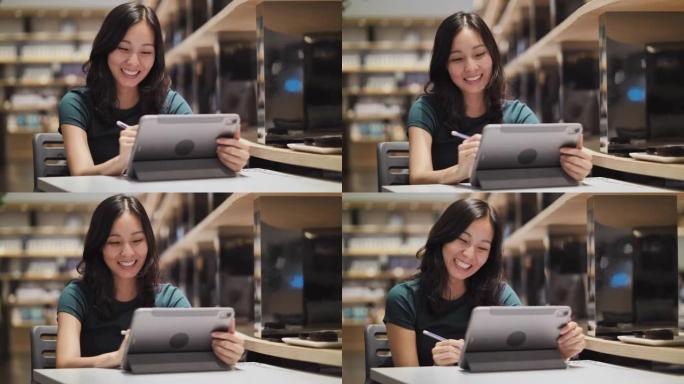 亚洲女性使用数字平板电脑进行创意工作，为理想工作写作