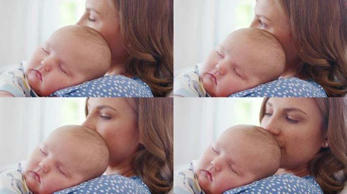 安静的男婴在母亲的肩膀上睡觉的特写镜头-慢动作