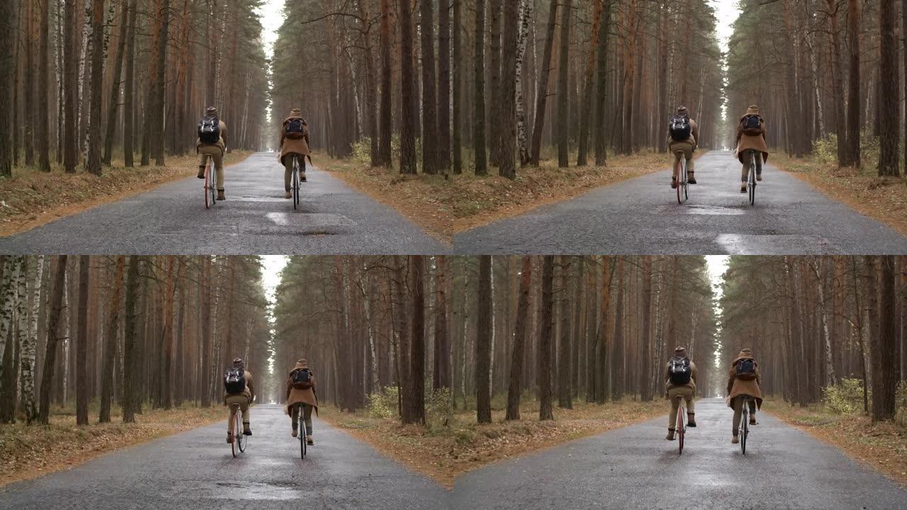情侣在雨中骑自行车的后视图