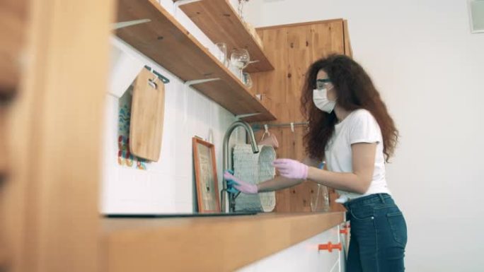 一个女人正在用消毒剂打扫厨房