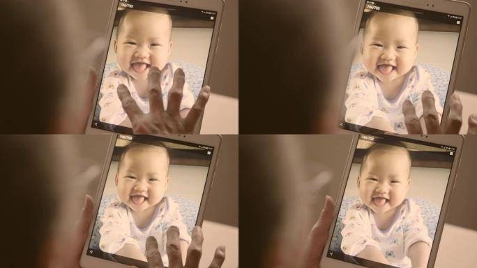 平板电脑显示: 与家人一起笑的婴儿