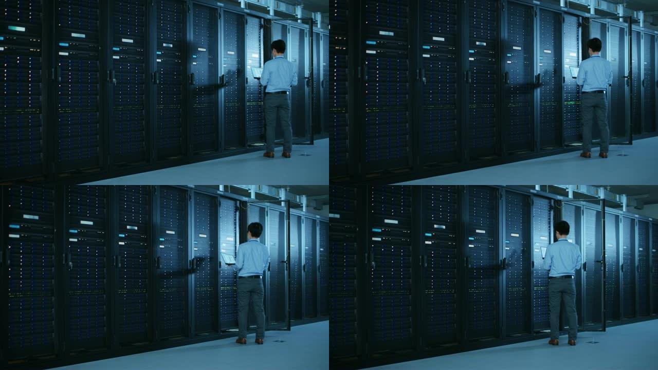 在现代数据中心: IT工程师使用服务器机架，使用笔记本电脑进行维护和诊断。检查系统的稳定性