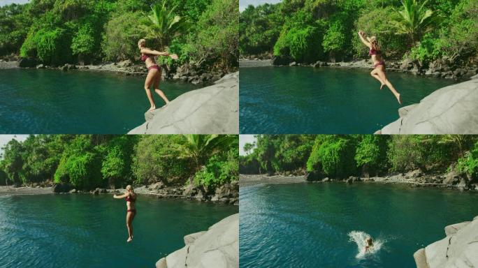 年轻漂亮的女人跳进热带丛林游泳池