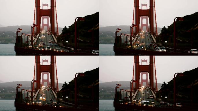 中速拍摄的汽车交通灯在夏季日落的标志性金门大桥旧金山加利福尼亚。