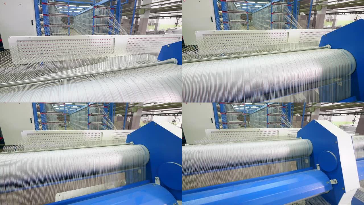 工厂织机在设施室内编织白色纤维。