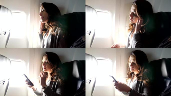 年轻女性商务旅客在飞行中调整耳塞