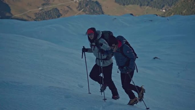 山地冒险。雪道上的年轻夫妇