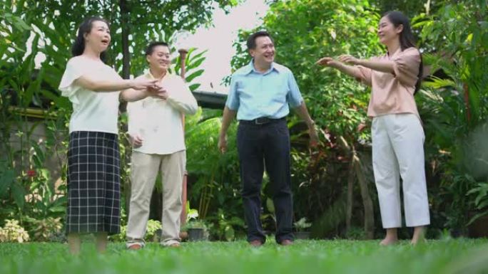 亚洲成熟成人运动组，在花园里摆臂。