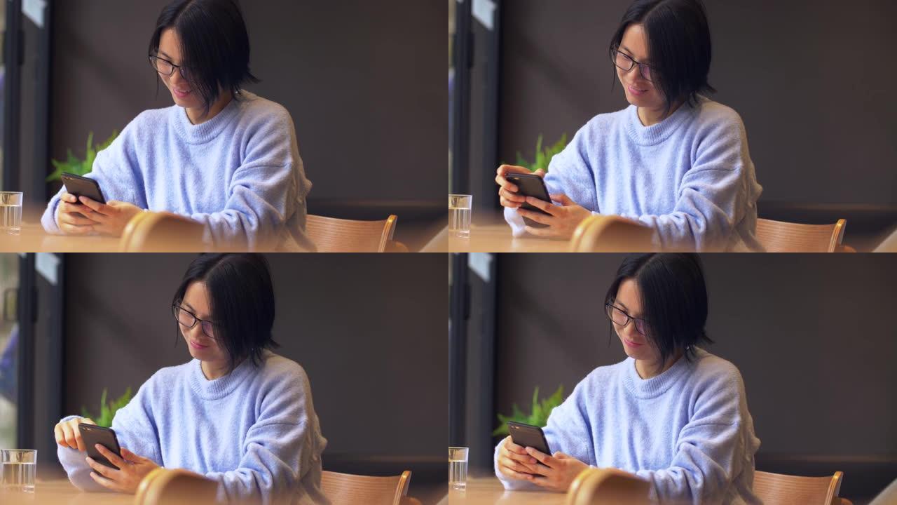 年轻的中国妇女正在玩手机